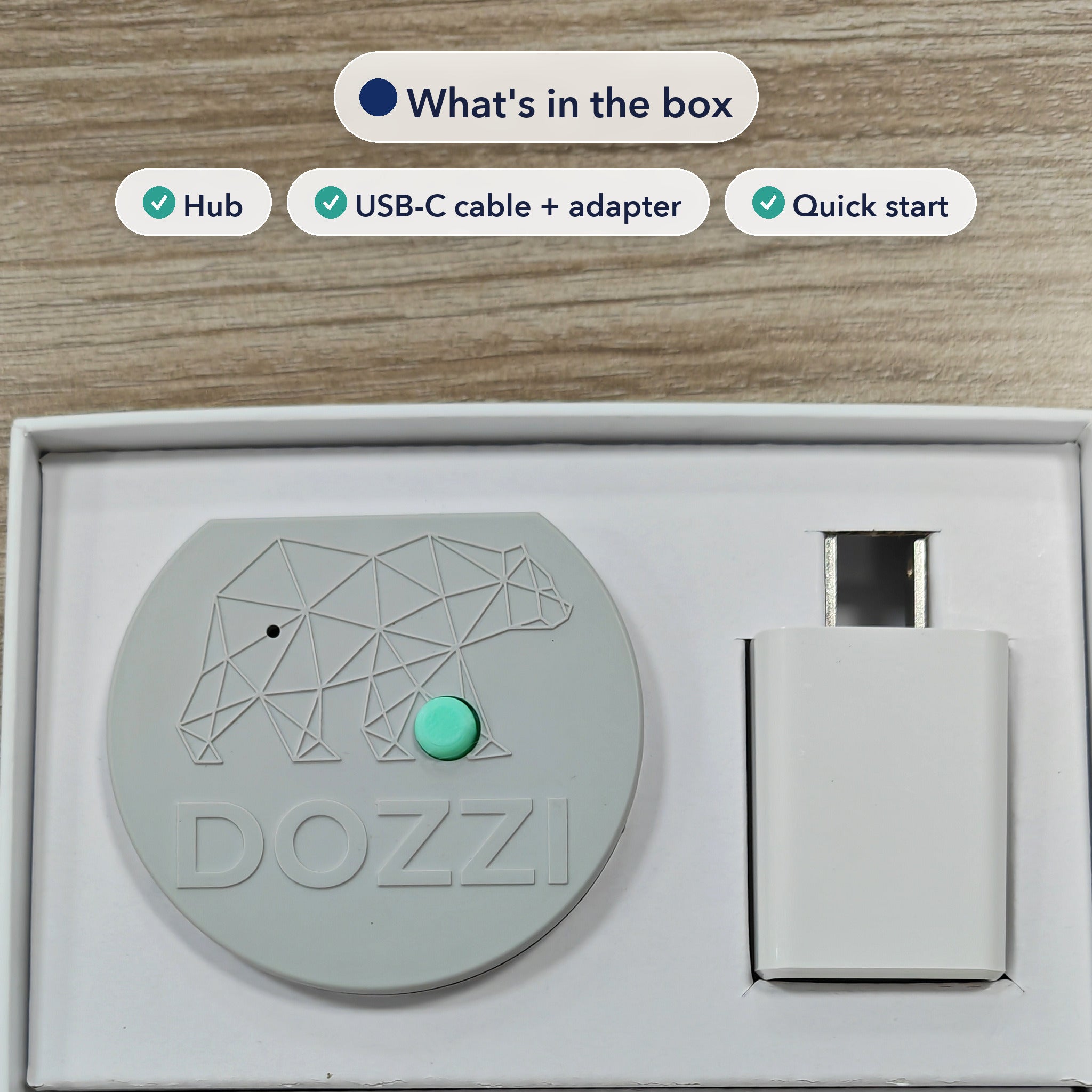 The Dozzi Base and its USB power adapter seated in the retail box tray